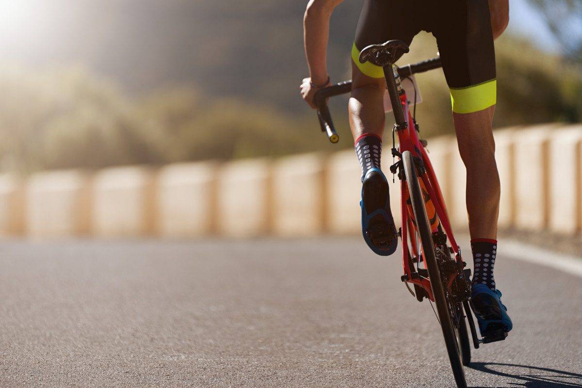 a cyclist riding down a road