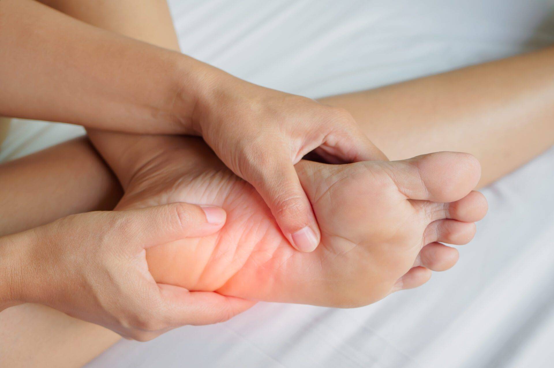 Closeup young woman feeling pain in her foot at home. Healthcare