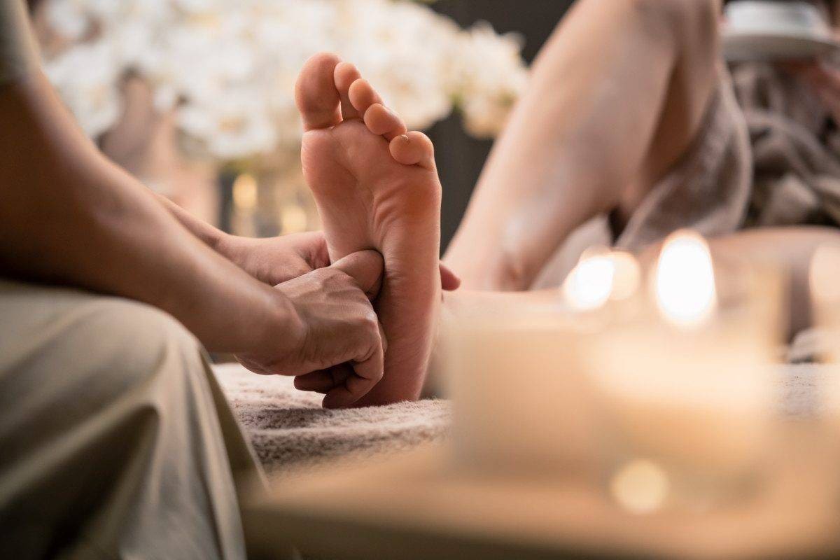 Woman having reflexology foot massage in wellness spa